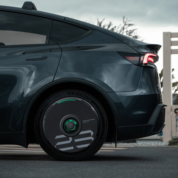 HALODISC 2 black wheel cover with custom number and green accent ring on a Tesla Model Y rear wheel