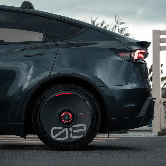 HALODISC 2 black wheel cover with custom number and red accent ring on a Tesla Model Y rear wheel